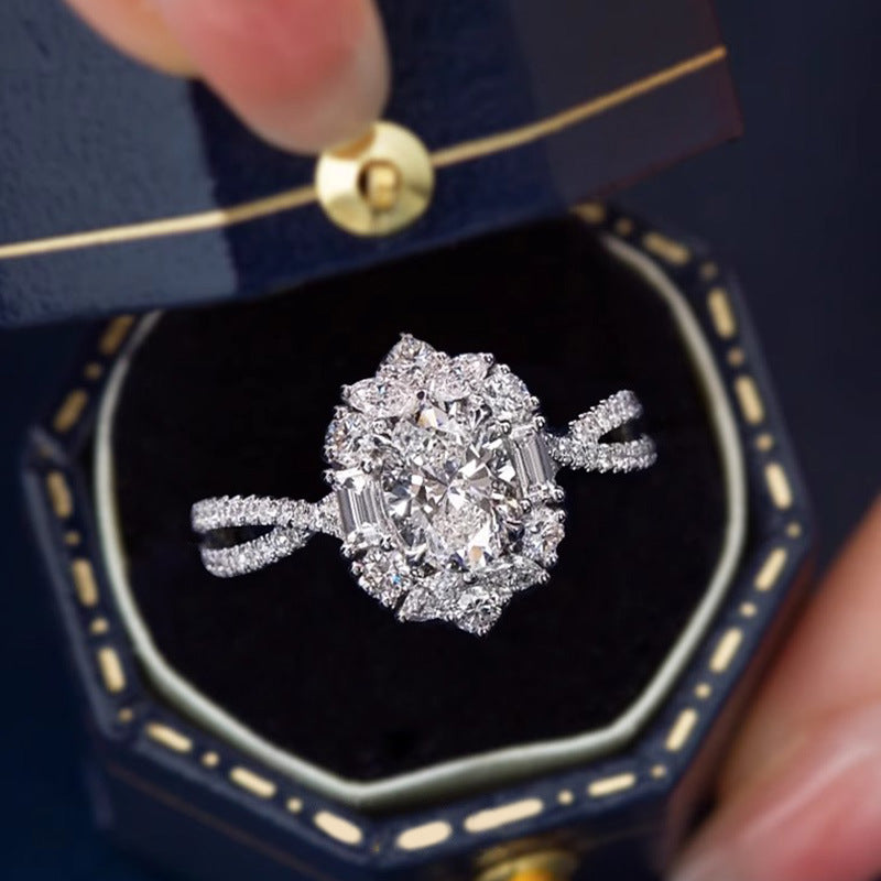 Oval Moissanite Cluster Ring displayed in a jewelry box, white gold cluster setting with accent zircon