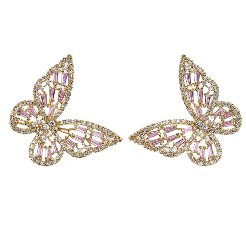 Butterfly Dangle Earrings on white background, gold butterfly wings with pink baguette crystals and pave outline