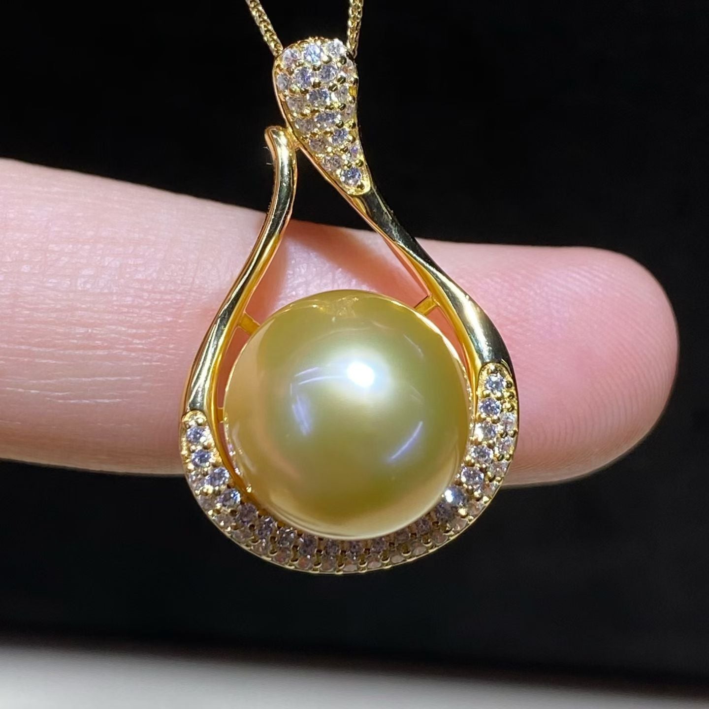 South Sea Pearl Necklace, golden pearl pendant with gold chain, dark background