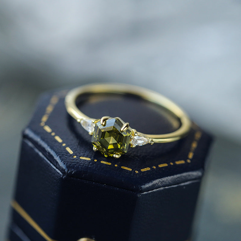 Gold Wedding Party Ring displayed on a navy velvet ring cone, close-up of the gemstone