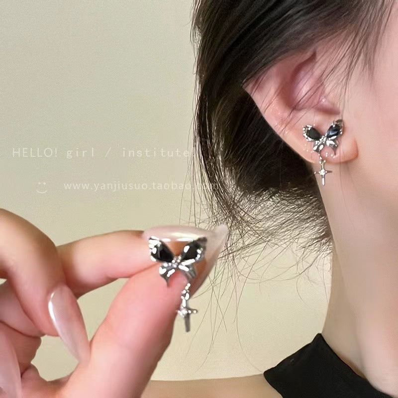 Model wearing silver butterfly-shaped stud earring, close-up on ear, product detail photo for Aurelie jewelry