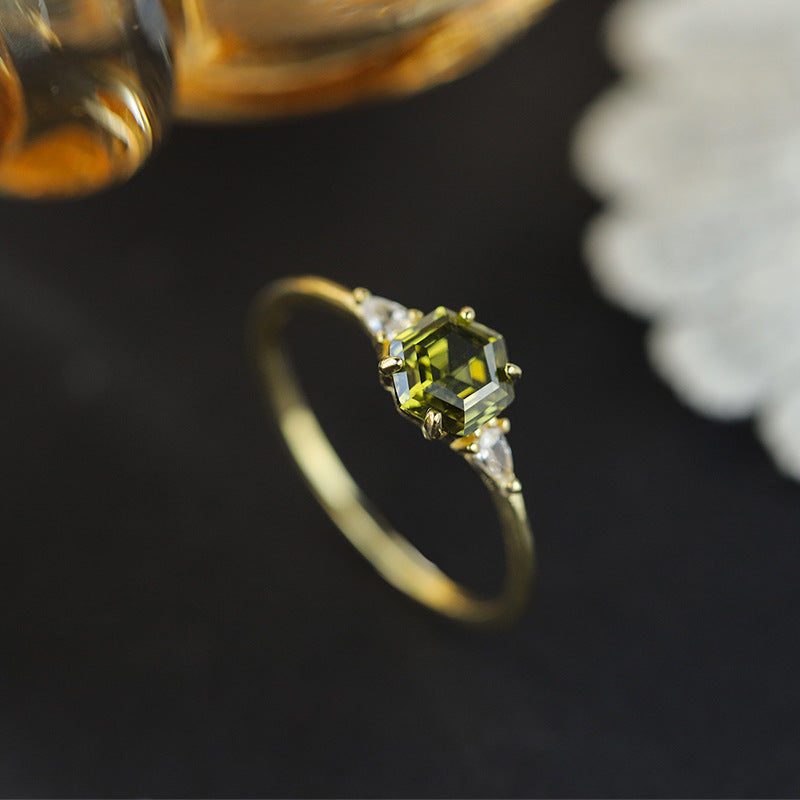 Gold Wedding Party Ring styled on dark surface with decorative flower and gold vase