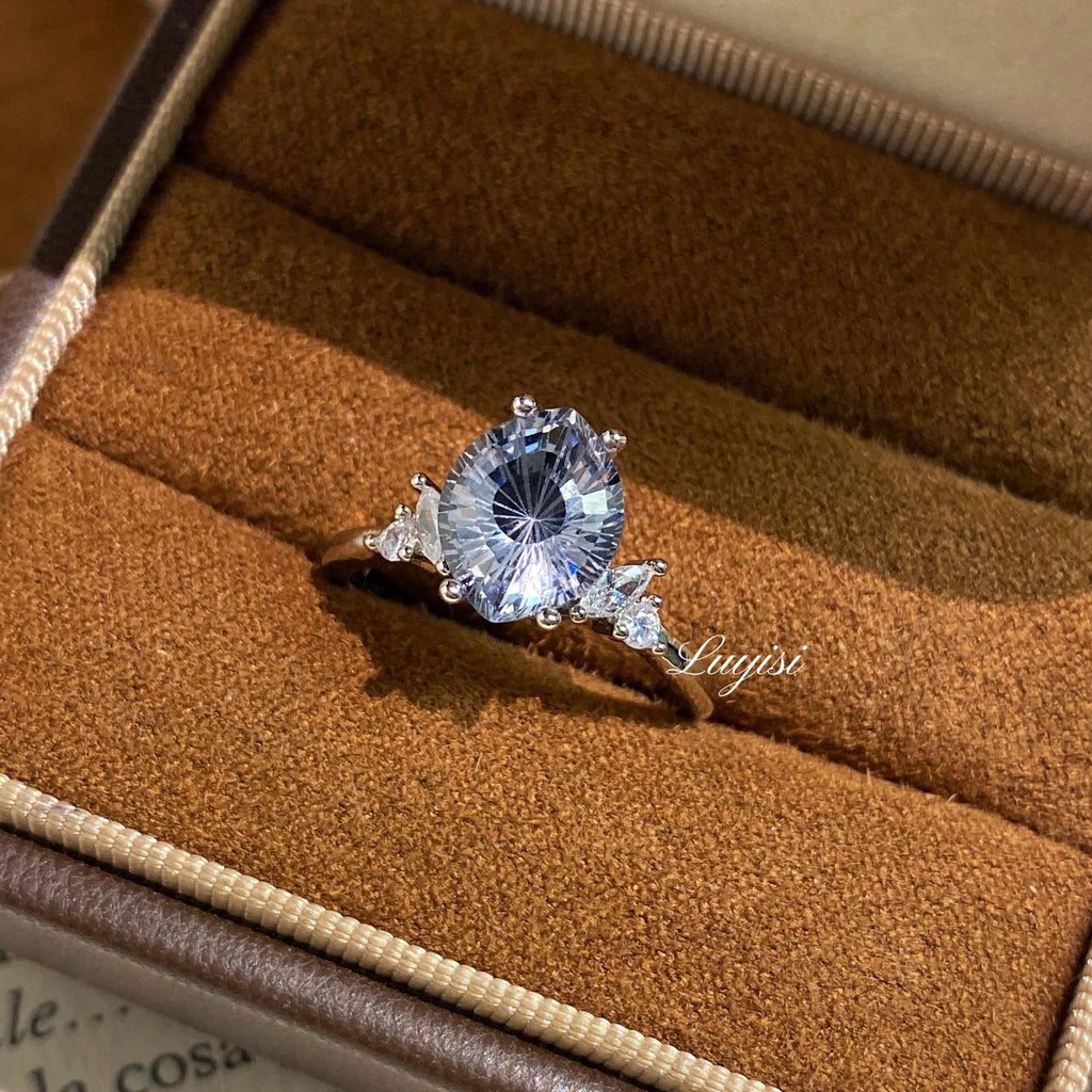 Firework-Cut Moissanite Ring in gray displayed in a ring box, faceted center stone