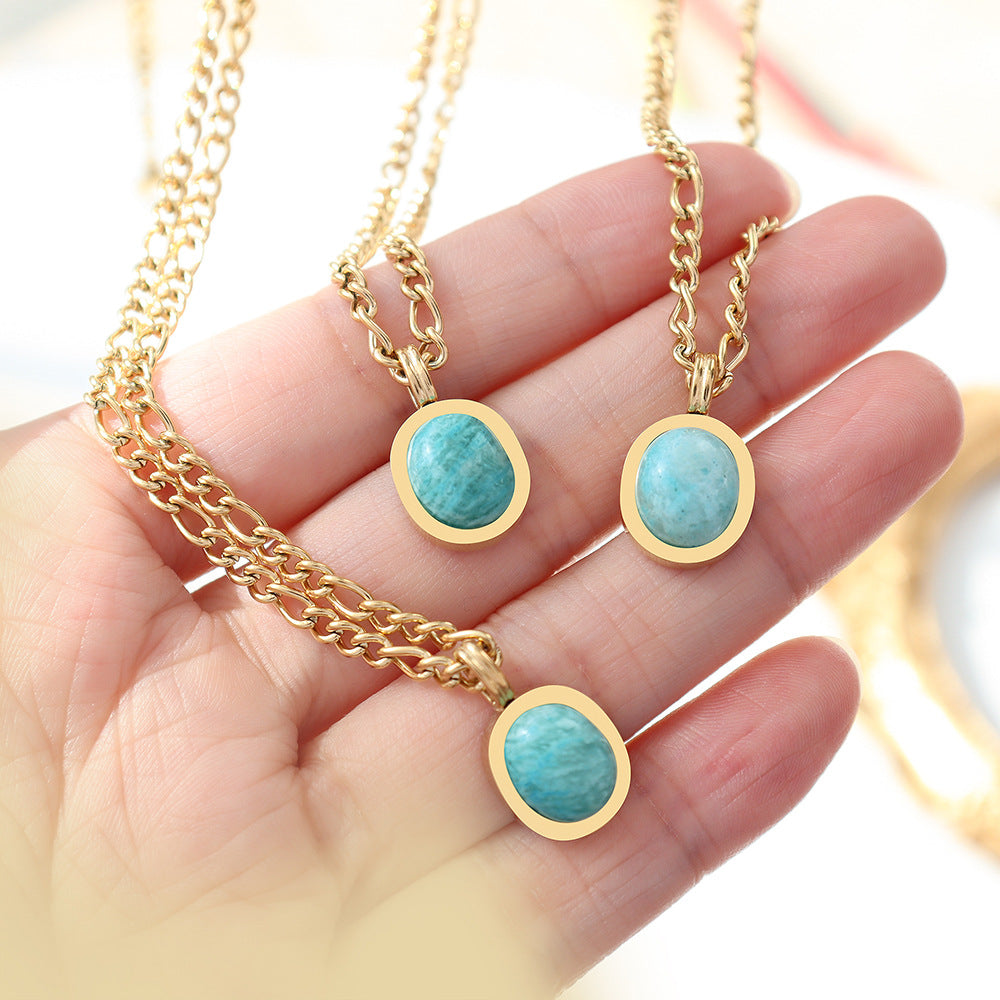 Three Amazonite Pendant Necklaces held in hand, showing natural stone color variation
