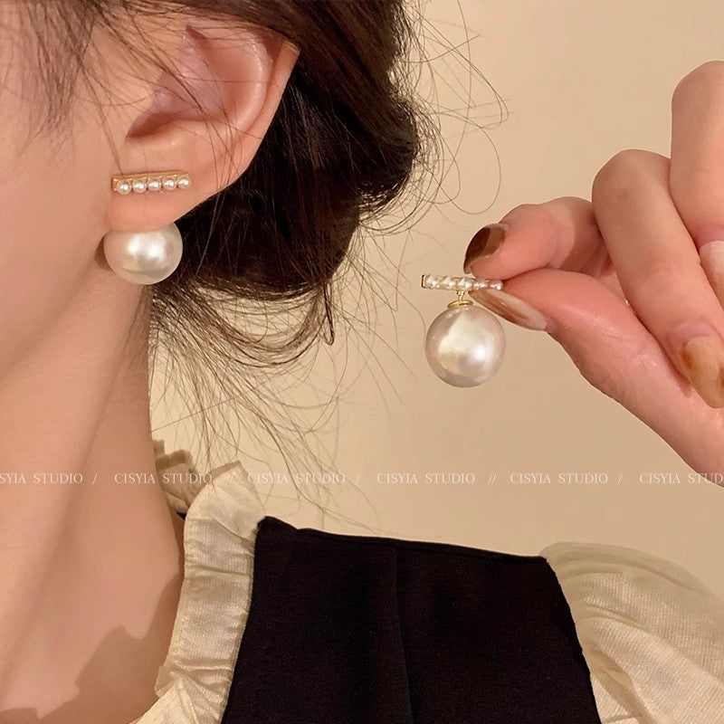 Pearl Drop Earrings worn in full dangle style, gold bar stud with detachable pearl drop on model's ear