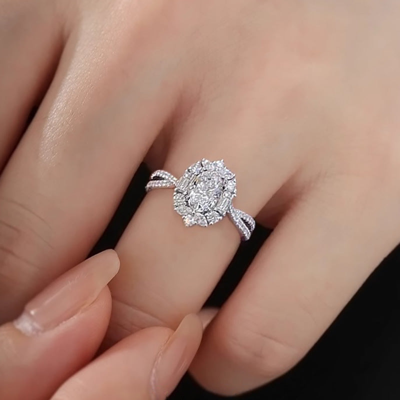 Oval Moissanite Cluster Ring worn on finger, showing the halo cluster setting and split shank band