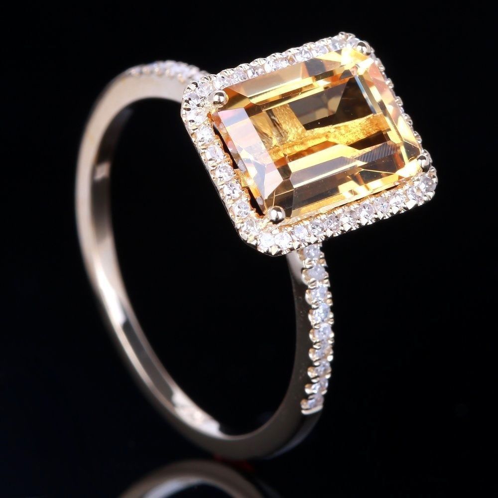 Champagne Gemstone Engagement Ring with emerald-cut champagne stone and pave halo, dark background close-up