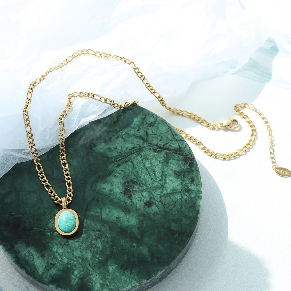Amazonite Pendant Necklace displayed on green stone, gold curb chain with oval pendant