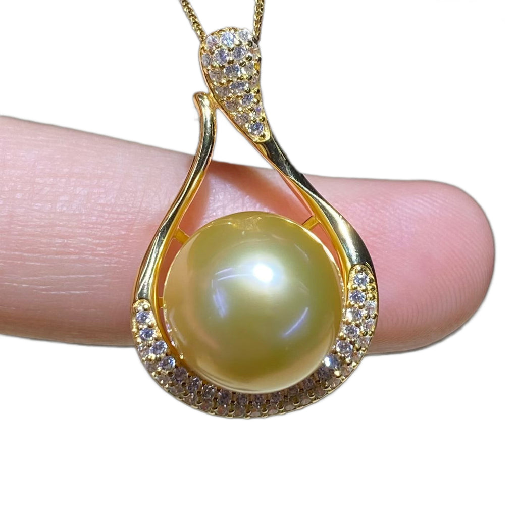 South Sea Pearl Necklace pendant on fingertip, white background