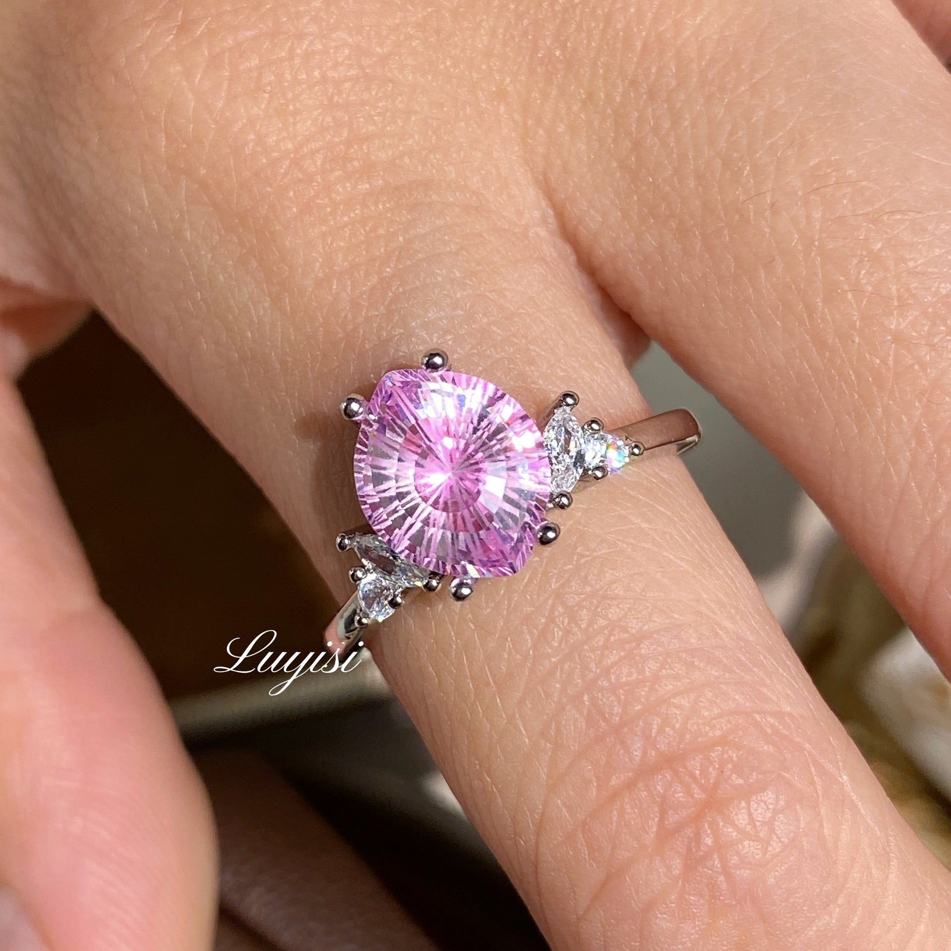 Firework-Cut Moissanite Ring in pink worn on finger, showing faceted stone sparkle