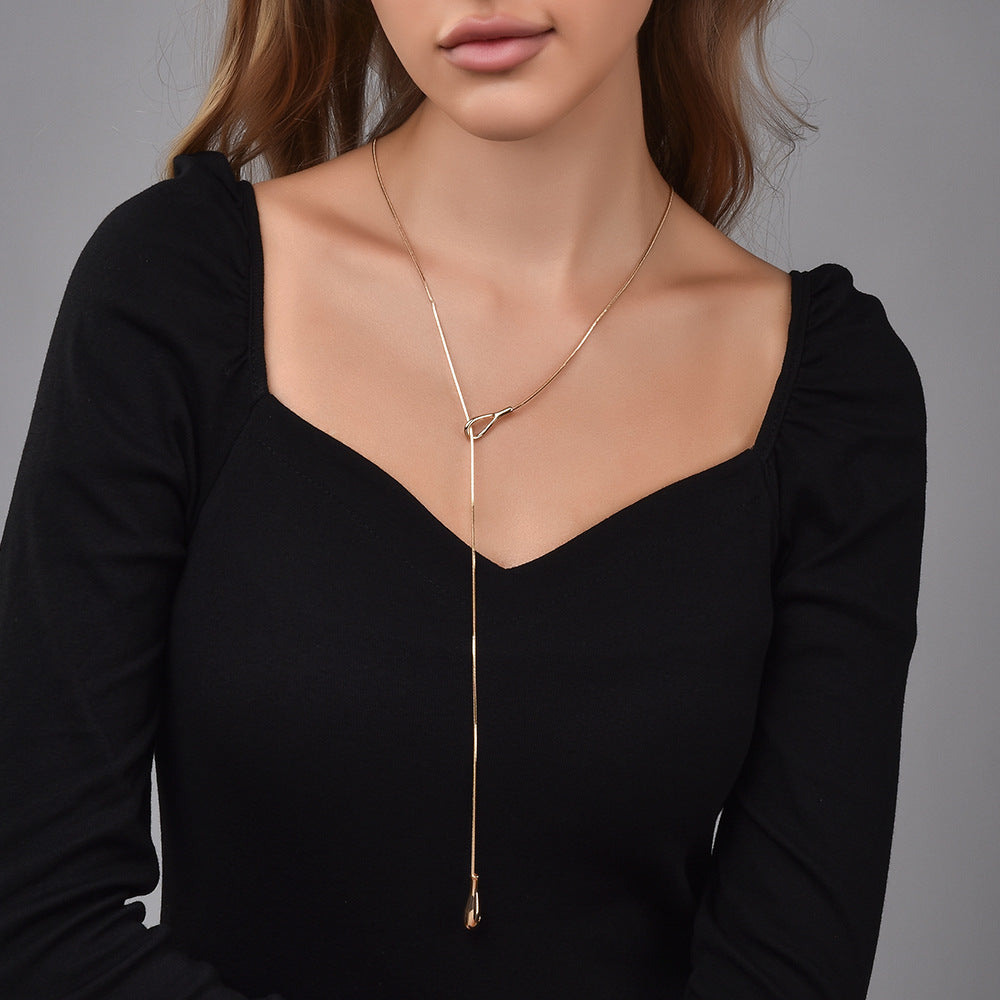 Model wearing gold Lariat Snake Chain Necklace, close-up showing Y-shape drop at neckline